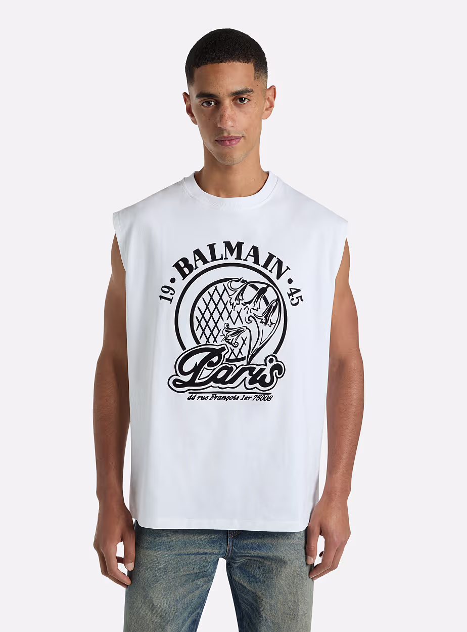 Balmain Paris Sleeveless Graphic T-Shirt Elevate your casual wardrobe with this premium white sleeveless T-shirt from Balmain Paris. Designed with a bold black logo print and signature Paris-inspired artwork, it combines luxury fashion with modern streetwear aesthetics. The clean white base and relaxed sleeveless cut make it ideal for warm weather and effortless styling. - Image 4